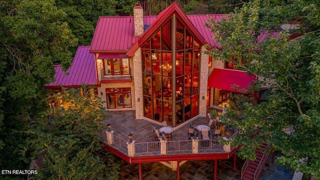 311 Deerwood Ln, Lafollette, TN 37766 - rear view of property with a standing seam roof, a metal roof, a chimney, and stone siding