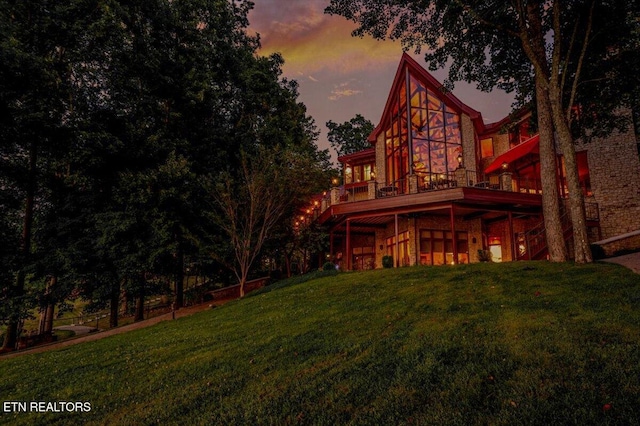 311 Deerwood Ln, Lafollette, TN 37766 - back of property at dusk with a lawn and a deck