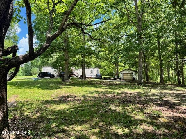 1101 Franklin Loop, Clarkrange, TN 38553 - view of grassy yard with a detached garage