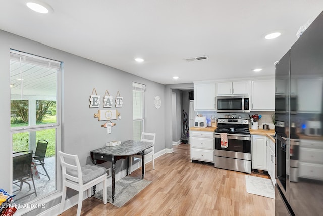 121 N Niota Rd, Englewood, TN 37329 - kitchen with stainless steel appliances, white cabinets, light wood finished floors, tasteful backsplash, and recessed lighting