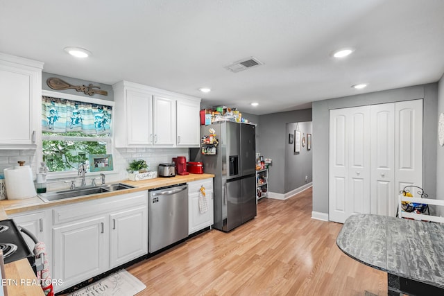 121 N Niota Rd, Englewood, TN 37329 - kitchen with appliances with stainless steel finishes, light countertops, white cabinets, backsplash, and recessed lighting