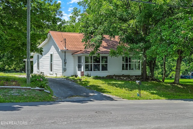 121 N Niota Rd, Englewood, TN 37329 - view of front of home with asphalt driveway, a front yard, and a metal roof