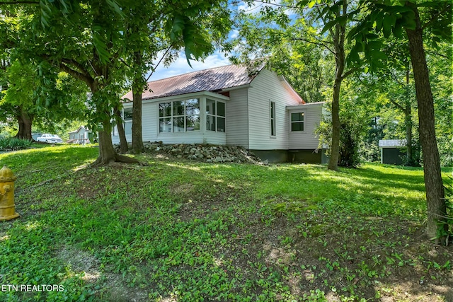 121 N Niota Rd, Englewood, TN 37329 - view of property exterior featuring a metal roof and a yard