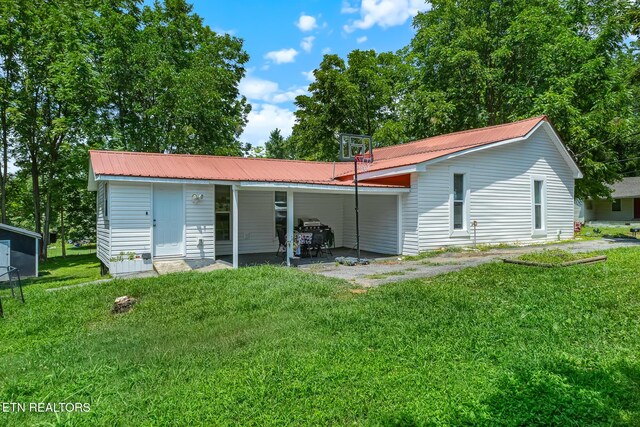 121 N Niota Rd, Englewood, TN 37329 - back of house with a lawn and a metal roof