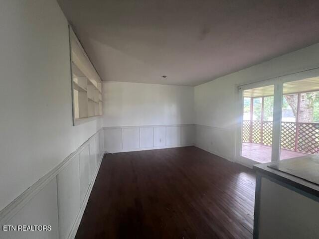 114 Red Cedar Rd, Lafollette, TN 37766 - spare room featuring wood finished floors, a wainscoted wall, and a decorative wall