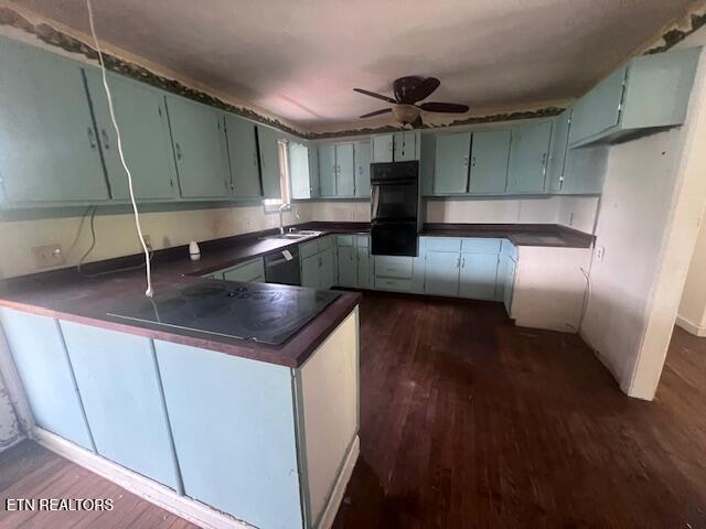 114 Red Cedar Rd, Lafollette, TN 37766 - kitchen with dark countertops, dark wood-type flooring, a peninsula, and black appliances