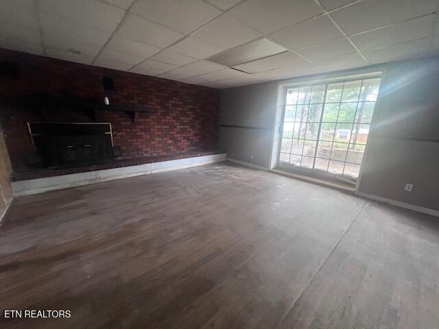 114 Red Cedar Rd, Lafollette, TN 37766 - unfurnished living room with a drop ceiling and wood finished floors