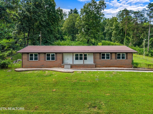 221 Greer Ln, Tazewell, TN 37879 - single story home with brick siding, a front yard, and a metal roof