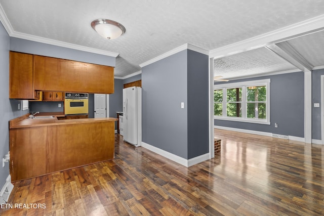 221 Greer Ln, Tazewell, TN 37879 - kitchen with white appliances, brown cabinets, dark wood-style floors, and crown molding