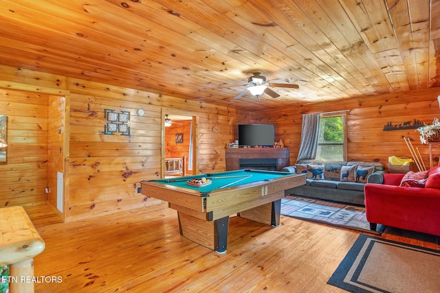 1130 Sharp Rd, Sevierville, TN 37876 - playroom with billiards, a fireplace, a ceiling fan, light wood finished floors, and wood walls