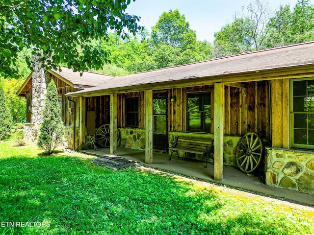 2255 Citico Rd, Vonore, TN 37885 - back of property with stone siding, a yard, and a patio