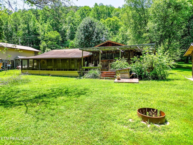 2255 Citico Rd, Vonore, TN 37885 - view of grassy yard with a sunroom, a wooded view, and a wooden deck