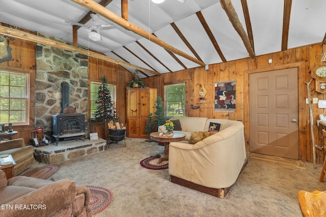 2255 Citico Rd, Vonore, TN 37885 - carpeted living area with wooden walls, a wood stove, and a ceiling fan