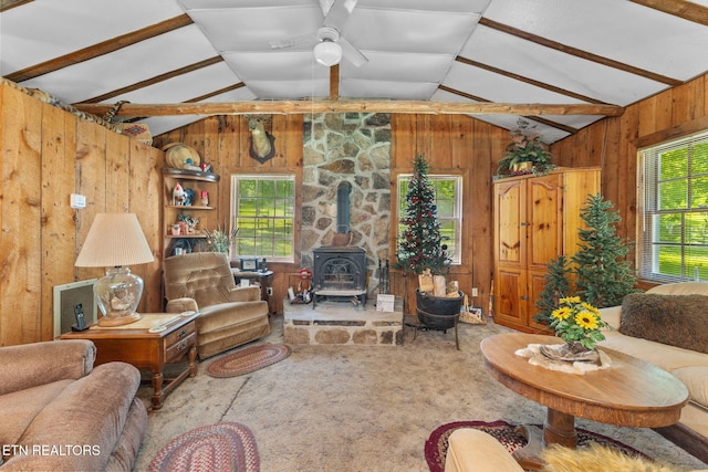 2255 Citico Rd, Vonore, TN 37885 - living area with wooden walls, lofted ceiling, a wood stove, a ceiling fan, and carpet floors