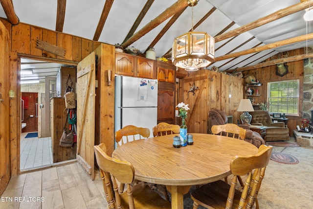 2255 Citico Rd, Vonore, TN 37885 - dining area featuring wooden walls, a chandelier, and light wood-type flooring