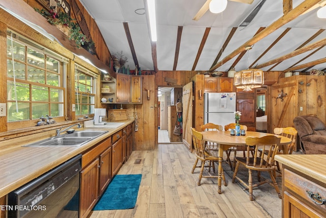 2255 Citico Rd, Vonore, TN 37885 - kitchen featuring freestanding refrigerator, black dishwasher, wooden walls, light wood-type flooring, and light countertops