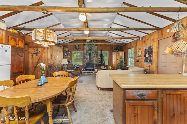 2255 Citico Rd, Vonore, TN 37885 - dining space with vaulted ceiling, wood walls, and a wood stove
