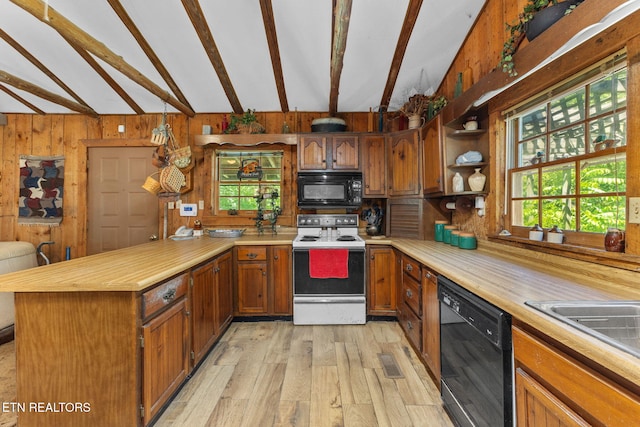 2255 Citico Rd, Vonore, TN 37885 - kitchen with black appliances, a peninsula, healthy amount of natural light, light wood-style flooring, and wooden walls