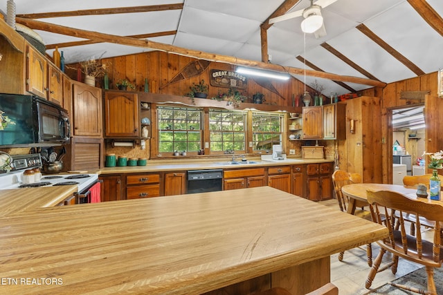 2255 Citico Rd, Vonore, TN 37885 - kitchen with black appliances, vaulted ceiling, light countertops, wooden walls, and brown cabinetry