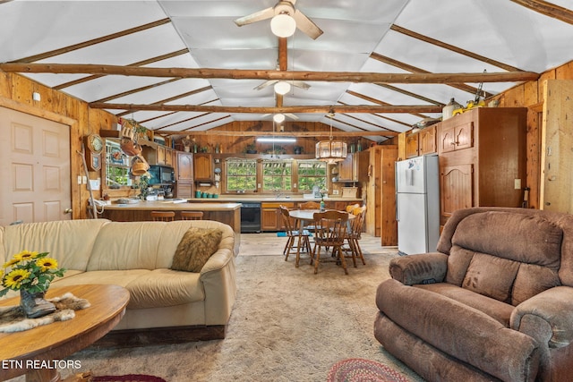 2255 Citico Rd, Vonore, TN 37885 - living room featuring vaulted ceiling, wooden walls, ceiling fan, and light colored carpet