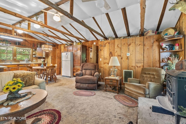 2255 Citico Rd, Vonore, TN 37885 - living room with vaulted ceiling, wood walls, light carpet, and a wood stove