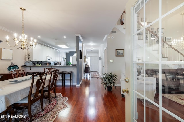 614 Chapel Point Ln, Knoxville, TN 37934 - dining space featuring a chandelier, dark wood-type flooring, stairs, recessed lighting, and ornamental molding