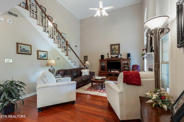 614 Chapel Point Ln, Knoxville, TN 37934 - living room with dark wood-style floors, ceiling fan, a towering ceiling, a fireplace, and stairs