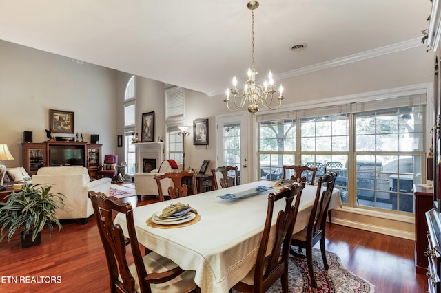 614 Chapel Point Ln, Knoxville, TN 37934 - dining space featuring a chandelier, dark wood finished floors, a fireplace, healthy amount of natural light, and ornamental molding