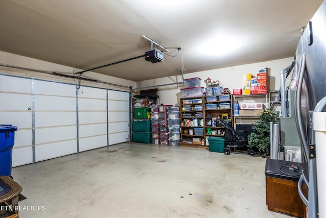 614 Chapel Point Ln, Knoxville, TN 37934 - garage featuring a garage door opener and freestanding refrigerator