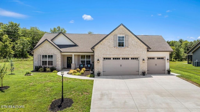 140 Walelu Trl, Vonore, TN 37885 - view of front of home with concrete driveway, a front lawn, a shingled roof, an attached garage, and brick siding
