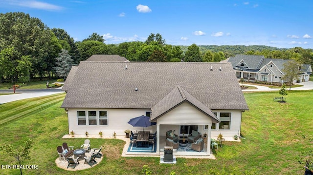 140 Walelu Trl, Vonore, TN 37885 - back of property with a yard, a patio area, an outdoor living space with a fire pit, and a shingled roof