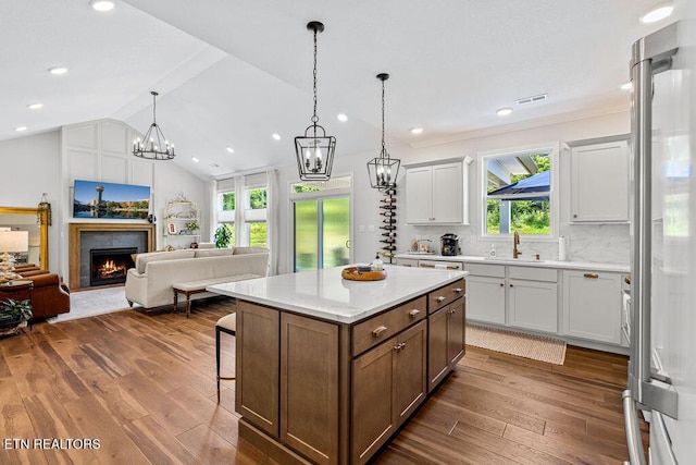 140 Walelu Trl, Vonore, TN 37885 - kitchen with dark wood-type flooring, light countertops, high end refrigerator, a breakfast bar area, and vaulted ceiling