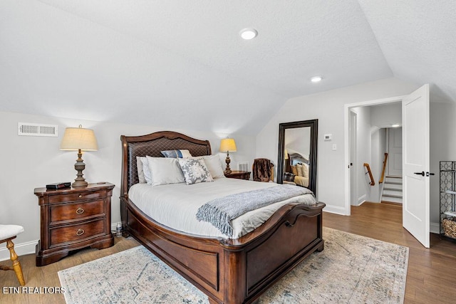 140 Walelu Trl, Vonore, TN 37885 - bedroom featuring lofted ceiling, wood finished floors, and a textured ceiling