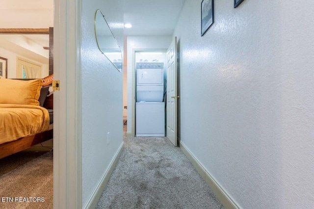 541 Johnson Ln Unit 2, Gatlinburg, TN 37738 - hallway featuring carpet, stacked washer / dryer, and a textured wall