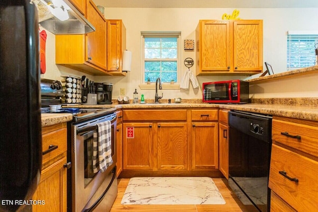 516 Proffitt Rd Unit 2, Gatlinburg, TN 37738 - kitchen featuring black appliances, under cabinet range hood, light wood-style flooring, light countertops, and brown cabinets