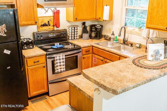 516 Proffitt Rd Unit 2, Gatlinburg, TN 37738 - kitchen with stainless steel electric stove, freestanding refrigerator, light countertops, and range hood