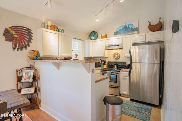 520 Proffitt Rd Unit 1, Gatlinburg, TN 37738 - kitchen with stainless steel appliances, under cabinet range hood, rail lighting, a peninsula, and a breakfast bar area