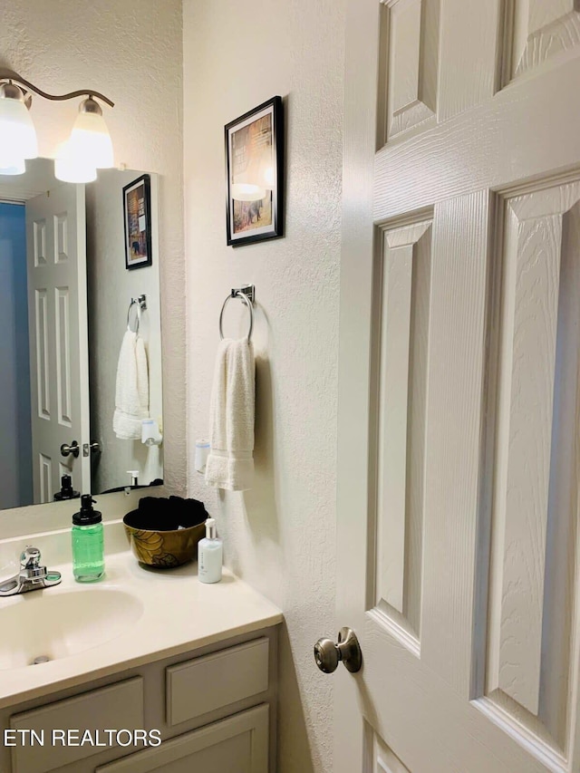 520 Proffitt Rd Unit 1, Gatlinburg, TN 37738 - bathroom with a textured wall and vanity