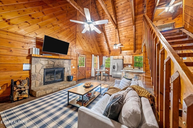 4372 Boogertown Rd Unit 2, Sevierville, TN 37876 - living area featuring wooden walls, a ceiling fan, wood finished floors, high vaulted ceiling, and a wood ceiling with exposed beams