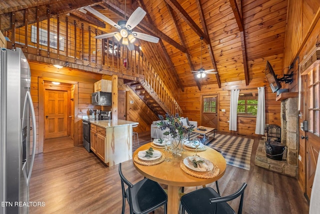 4372 Boogertown Rd Unit 2, Sevierville, TN 37876 - dining space featuring a ceiling fan, light wood finished floors, stairway, a wood ceiling with exposed beams, and wooden walls