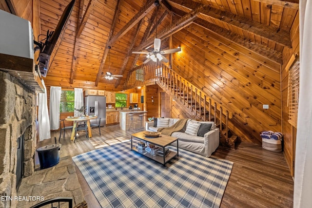 4372 Boogertown Rd Unit 2, Sevierville, TN 37876 - living room featuring wood walls, high vaulted ceiling, stairs, a wood ceiling with exposed beams, and a ceiling fan