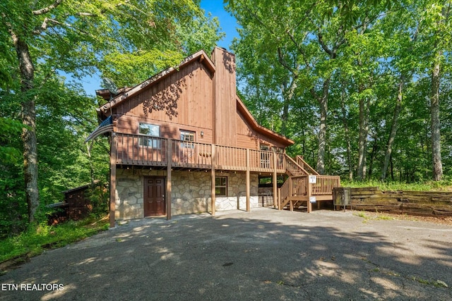 4372 Boogertown Rd Unit 2, Sevierville, TN 37876 - view of front of house with stone siding, a chimney, a deck, and stairs