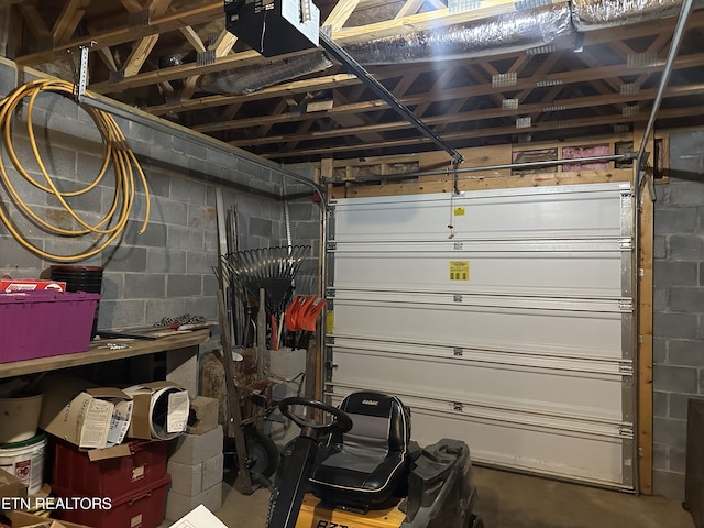 667 Pine Hollow Rd, Jacksboro, TN 37757 - garage with concrete block wall and a garage door opener