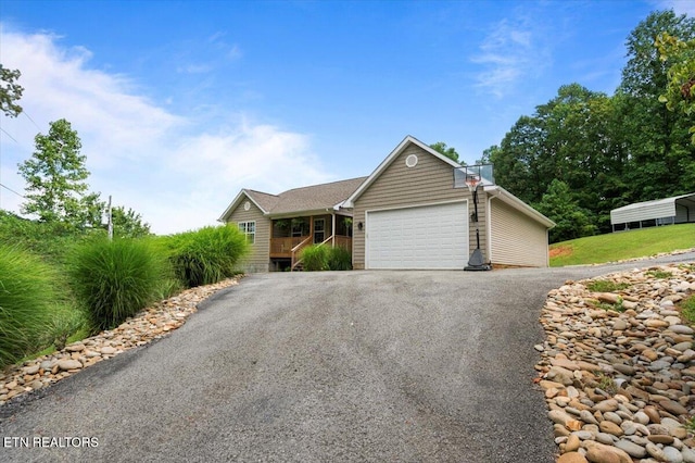 667 Pine Hollow Rd, Jacksboro, TN 37757 - ranch-style house with driveway and a garage