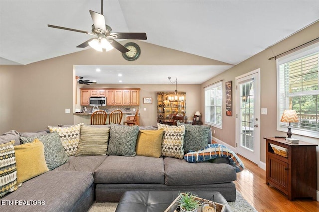 667 Pine Hollow Rd, Jacksboro, TN 37757 - living room with light wood-style floors, ceiling fan, vaulted ceiling, healthy amount of natural light, and a chandelier