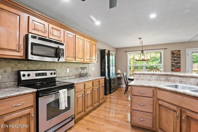 667 Pine Hollow Rd, Jacksboro, TN 37757 - kitchen featuring appliances with stainless steel finishes, light wood-style floors, light countertops, tasteful backsplash, and recessed lighting