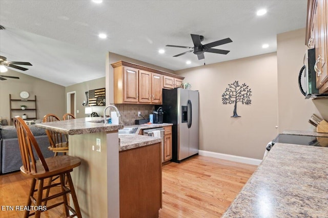 667 Pine Hollow Rd, Jacksboro, TN 37757 - kitchen featuring ceiling fan, stainless steel appliances, a kitchen breakfast bar, a peninsula, and recessed lighting