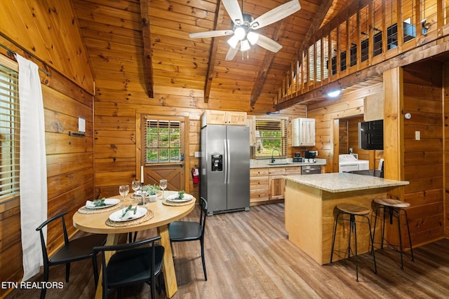 4372 Boogertown Rd Unit 4, Sevierville, TN 37876 - kitchen with stainless steel appliances, light wood-type flooring, wood walls, a wooden ceiling with exposed beams, and a peninsula