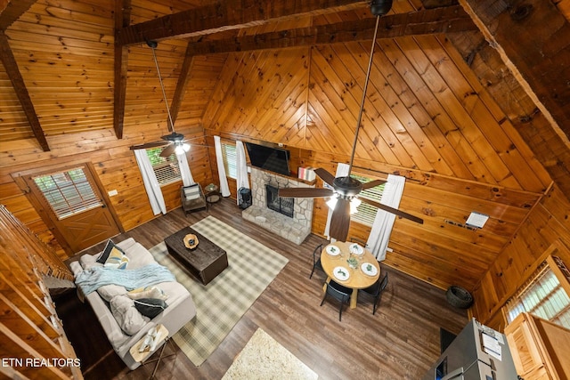 4372 Boogertown Rd Unit 4, Sevierville, TN 37876 - unfurnished living room featuring a ceiling fan, wood walls, a wood ceiling with exposed beams, wood finished floors, and high vaulted ceiling