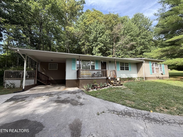 1386 Walker Ford Rd, Maynardville, TN 37807 - view of front facade with asphalt driveway, a carport, a front lawn, and a porch